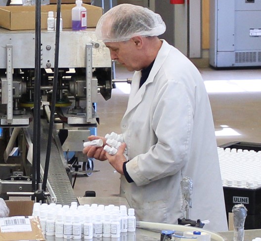 EMS staff member sorting small white bottles